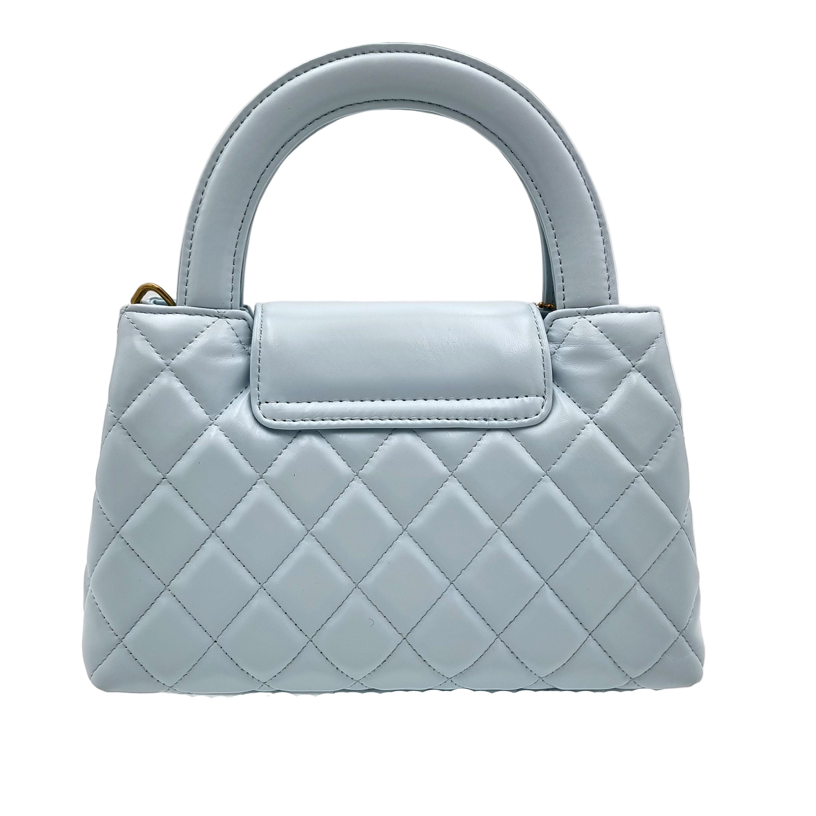 Light blue quilted real leather handbag on a white background